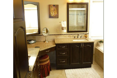 Drop-in bathtub - large traditional master beige tile ceramic tile and brown floor drop-in bathtub idea in Ottawa with raised-panel cabinets, dark wood cabinets, brown walls, an undermount sink and granite countertops