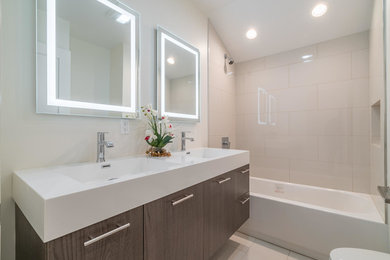 Mid-sized transitional 3/4 beige tile and porcelain tile porcelain tile and white floor bathroom photo in Chicago with flat-panel cabinets, brown cabinets, gray walls, an integrated sink, quartz countertops and white countertops