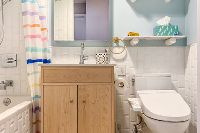 Example of a transitional white tile and subway tile multicolored floor and single-sink bathroom design in New York with flat-panel cabinets, light wood cabinets, blue walls, yellow countertops and a built-in vanity