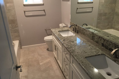 Example of a bathroom design in Hawaii with granite countertops