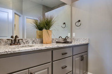 Bathroom - transitional 3/4 bathroom idea in Omaha with raised-panel cabinets and a built-in vanity