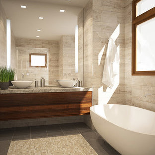 Design ideas for a small modern master bathroom in San Francisco with a vessel sink, flat-panel cabinets, medium wood cabinets, limestone benchtops, a freestanding tub, beige tile, stone tile and brown walls.