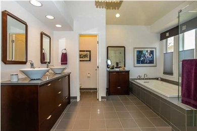 Minimalist master gray tile gray floor bathroom photo in New York with dark wood cabinets, a hinged shower door, white walls, a vessel sink and flat-panel cabinets