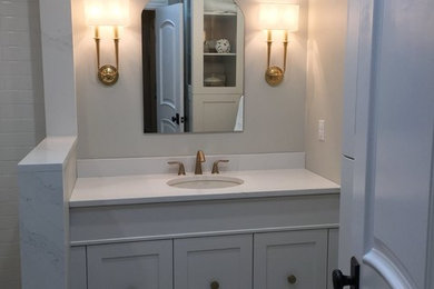 Inspiration for a mid-sized transitional 3/4 white tile and ceramic tile porcelain tile and gray floor corner shower remodel in Other with shaker cabinets, white cabinets, a two-piece toilet, gray walls, an undermount sink, quartz countertops, a hinged shower door and white countertops