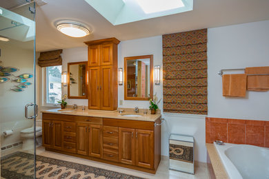 Example of a mid-sized master red tile and porcelain tile porcelain tile and white floor bathroom design in Other with raised-panel cabinets, medium tone wood cabinets, white walls, an undermount sink, quartz countertops, a hinged shower door and beige countertops