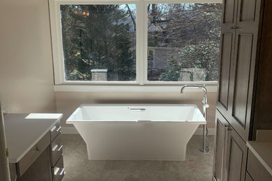 Freestanding bathtub - mid-sized traditional master porcelain tile and gray floor freestanding bathtub idea in DC Metro with beaded inset cabinets, dark wood cabinets, beige walls and white countertops