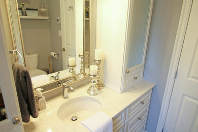 Mid-sized elegant master beige tile and ceramic tile ceramic tile bathroom photo in Vancouver with raised-panel cabinets, white cabinets, a one-piece toilet, gray walls, an undermount sink and quartzite countertops