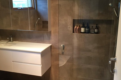 Mid-sized minimalist master bathroom photo in Adelaide with raised-panel cabinets