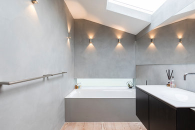 Design ideas for a medium sized modern family bathroom in London with raised-panel cabinets, a walk-in shower, a one-piece toilet, grey walls, a built-in sink and an open shower.