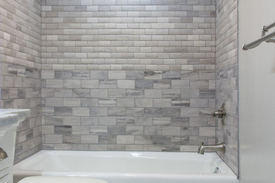 Inspiration for a mid-sized transitional kids' gray tile bathroom remodel in Cleveland with marble countertops