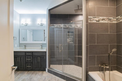Inspiration for a mid-sized timeless master brown tile and porcelain tile medium tone wood floor and brown floor bathroom remodel in DC Metro with recessed-panel cabinets, gray cabinets, gray walls, an undermount sink and a hinged shower door