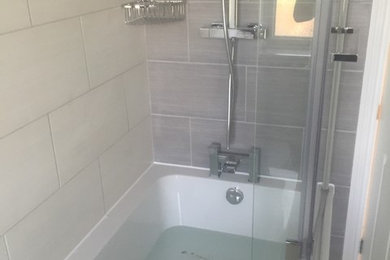 Photo of a traditional bathroom in Essex with freestanding cabinets and white cabinets.