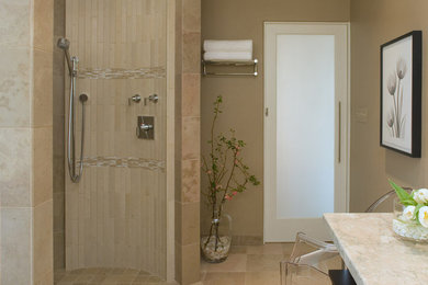 This is an example of a modern ensuite bathroom in New York with a walk-in shower, stone tiles, beige walls, limestone flooring, marble worktops and beige tiles.