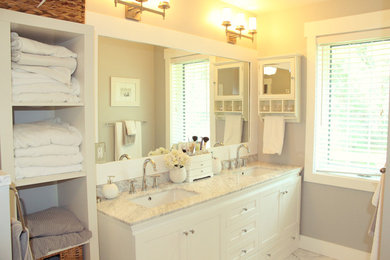 Inspiration for a mid-sized country master bathroom remodel in Other with a drop-in sink, white cabinets, marble countertops, gray walls and shaker cabinets