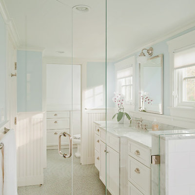 Example of a large classic master white tile and marble tile gray floor walk-in shower design in Providence with recessed-panel cabinets, white cabinets, blue walls, an undermount sink, marble countertops, a hinged shower door and gray countertops