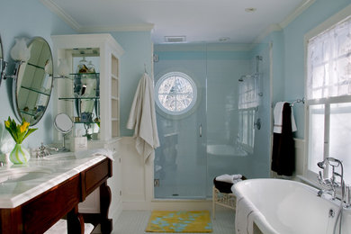 Design ideas for a medium sized traditional ensuite bathroom in Portland Maine with open cabinets, medium wood cabinets, a freestanding bath, an alcove shower, blue tiles, metro tiles, blue walls, mosaic tile flooring, a submerged sink and marble worktops.
