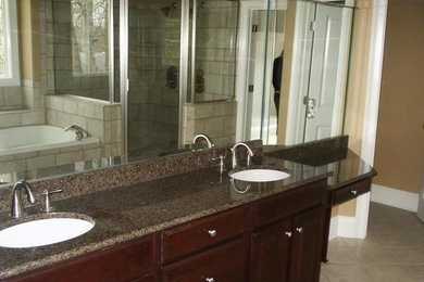 Bathroom - large master bathroom idea in Atlanta with a drop-in sink, dark wood cabinets, granite countertops and beige walls