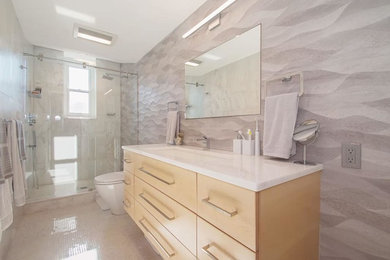 Bathroom - mid-sized transitional 3/4 mosaic tile floor and beige floor bathroom idea in Boston with flat-panel cabinets, light wood cabinets, a two-piece toilet, beige walls, an undermount sink and quartzite countertops