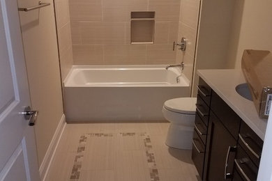 Bathroom - mid-sized traditional 3/4 white tile and stone slab ceramic tile bathroom idea in Other with flat-panel cabinets, dark wood cabinets, a one-piece toilet, beige walls, a drop-in sink and concrete countertops