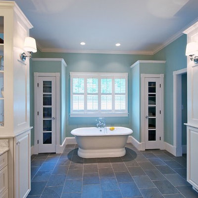 Bathroom - mid-sized traditional master white tile and stone slab slate floor bathroom idea in Orange County with recessed-panel cabinets, white cabinets, blue walls, marble countertops, an undermount sink and a hinged shower door