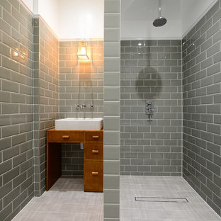 Inspiration for a medium sized traditional ensuite bathroom in London with freestanding cabinets, medium wood cabinets, porcelain flooring, a vessel sink, a walk-in shower, grey tiles, metro tiles and an open shower.