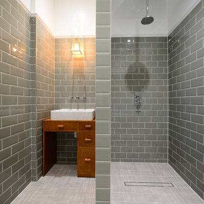 Bathroom - mid-sized transitional master gray tile and subway tile porcelain tile bathroom idea in London with furniture-like cabinets, medium tone wood cabinets and a vessel sink