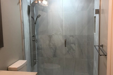 Double shower - mid-sized contemporary 3/4 gray tile and ceramic tile mosaic tile floor and gray floor double shower idea in Toronto with dark wood cabinets, gray walls, granite countertops, a hinged shower door and white countertops