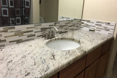 Inspiration for a small timeless 3/4 multicolored tile and mosaic tile ceramic tile and beige floor bathroom remodel in Denver with raised-panel cabinets, medium tone wood cabinets, a one-piece toilet, beige walls, an undermount sink and granite countertops