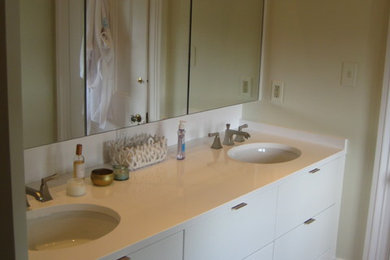 This is an example of a modern bathroom in New Orleans with engineered stone worktops.