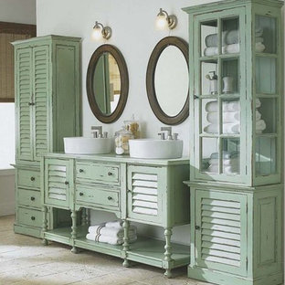 Inspiration for a small shabby-chic style master bathroom in Other with louvered cabinets, medium wood cabinets, a claw-foot tub, a one-piece toilet, beige tile, stone tile, multi-coloured walls, light hardwood floors, wood benchtops and a vessel sink.
