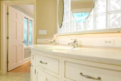 Example of a large classic master cork floor and brown floor bathroom design in Burlington with furniture-like cabinets, white cabinets, beige walls, an undermount sink and quartz countertops