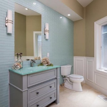 Bathroom with a mix of traditional vanity and modern glass wall.