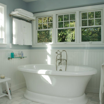 Bathroom with bead board and standing tub.