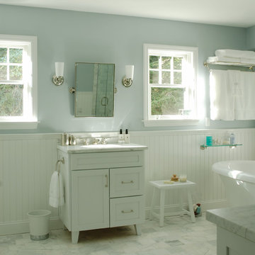Bathroom with bead board and standing tub.