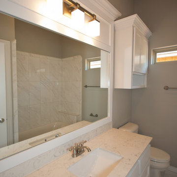 Bathroom with Contemporary Fixtures and White Cabinets