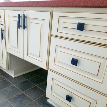 Bathroom with Cream Cabinets, Red Granite Counter top, and Grey Accents