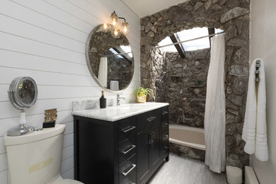 Свежая идея для дизайна: маленькая главная ванная комната в стиле фьюжн с фасадами с выступающей филенкой, черными фасадами, накладной ванной, душем в нише, унитазом-моноблоком, серой плиткой, плиткой из листового камня, белыми стенами, полом из ламината, консольной раковиной, мраморной столешницей, серым полом, открытым душем и белой столешницей для на участке и в саду - отличное фото интерьера