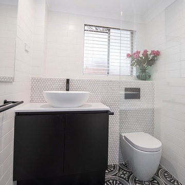 Bathroom with Penny feature tiles and patterned floor tiles