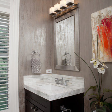 Bathroom with Silver Wallpaper and Marble Countertop