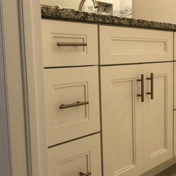Bathroom with White Shaker-Style Cabinets and Dark Granite Countertops