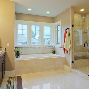 Bathroom with window over tub, custom shower and shower door, brown 2 sink vanit