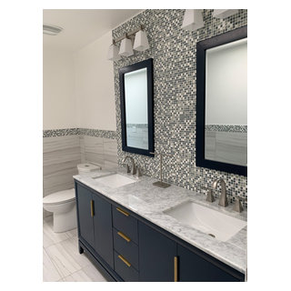 Bathroom wrapped with wainscoting, topped with mosaic glass tiles ...