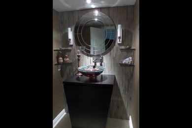 Example of a small trendy 3/4 gray tile and glass tile marble floor bathroom design in Los Angeles with a vessel sink, furniture-like cabinets, black cabinets, wood countertops and a one-piece toilet