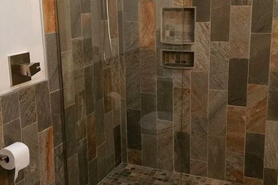 Example of a multicolored tile doorless shower design in Indianapolis