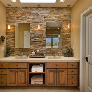 Inspiration for a timeless brown tile bathroom remodel in Phoenix with an integrated sink, raised-panel cabinets, medium tone wood cabinets and quartz countertops