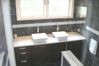 Doorless shower - mid-sized modern master gray tile and cement tile slate floor doorless shower idea in Bridgeport with a vessel sink, dark wood cabinets, marble countertops and gray walls