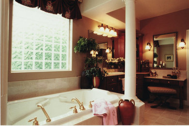 他の地域にあるおしゃれな浴室 (ドロップイン型浴槽、ベージュの壁、オーバーカウンターシンク) の写真