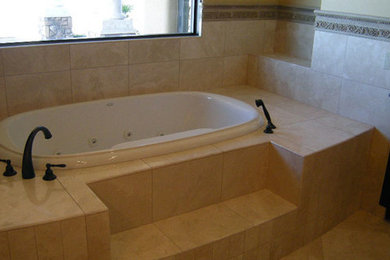 Example of a master beige tile alcove bathtub design in Phoenix