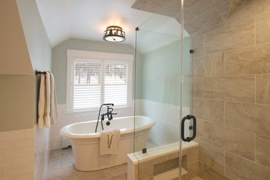 This is an example of a medium sized classic ensuite bathroom in Burlington with a freestanding bath, beige tiles, porcelain tiles, green walls, porcelain flooring, engineered stone worktops, an alcove shower, a two-piece toilet, beige floors and a hinged door.