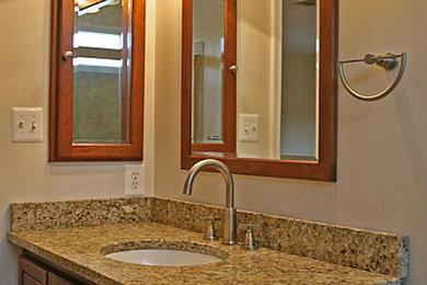 Example of a mid-sized transitional 3/4 bathroom design in Chicago with raised-panel cabinets, medium tone wood cabinets, beige walls, an undermount sink and granite countertops